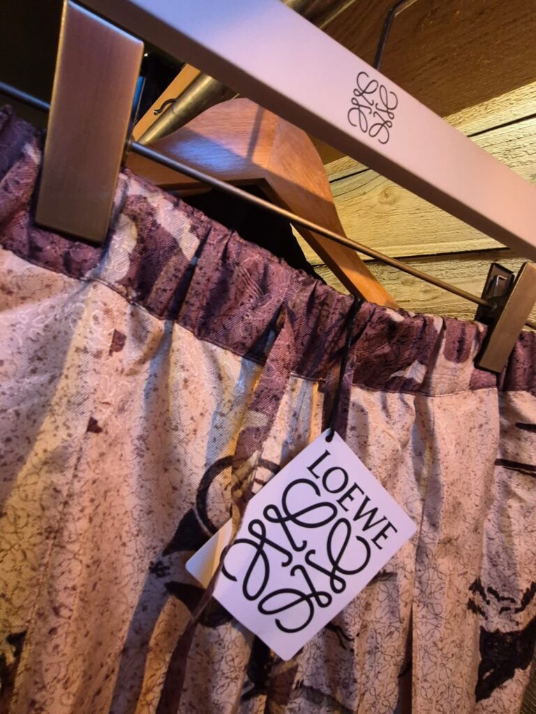 Loewe printed garment with its original designer tag, on a Loewe hanger